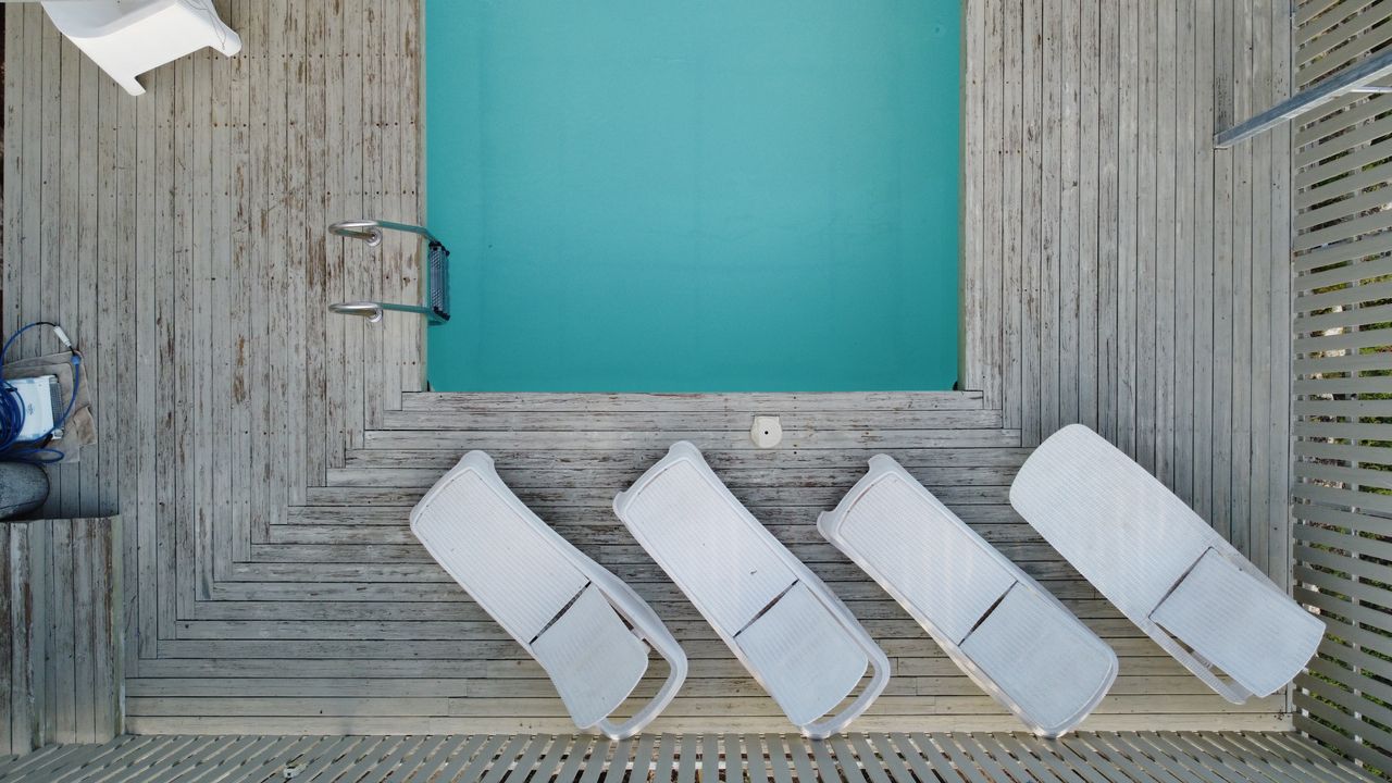 Top-down view of sunbeds and a small pool in Ta'oz, Israel, perfect for summer relaxation imagery.